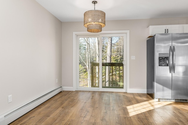 LOT9 Westhaven Ln, Wells, ME 04090 - unfurnished dining area with baseboard heating, wood finished floors, baseboards, and a chandelier