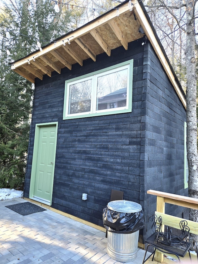 view of home's exterior with an outdoor structure