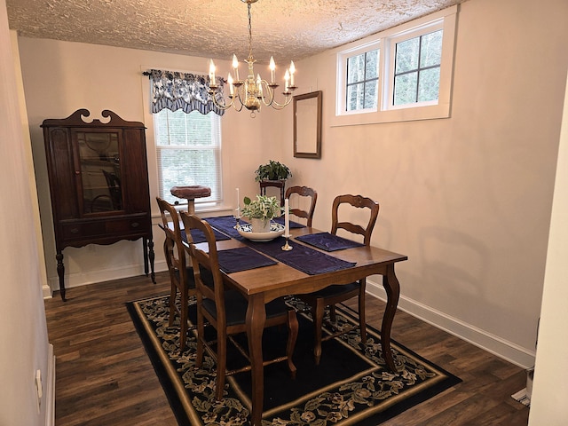 dining space featuring a chandelier, a textured ceiling, and dark hardwood / wood-style flooring