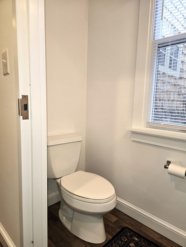 bathroom with hardwood / wood-style floors and toilet