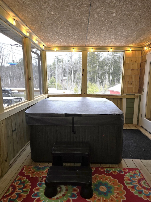 sunroom with a hot tub