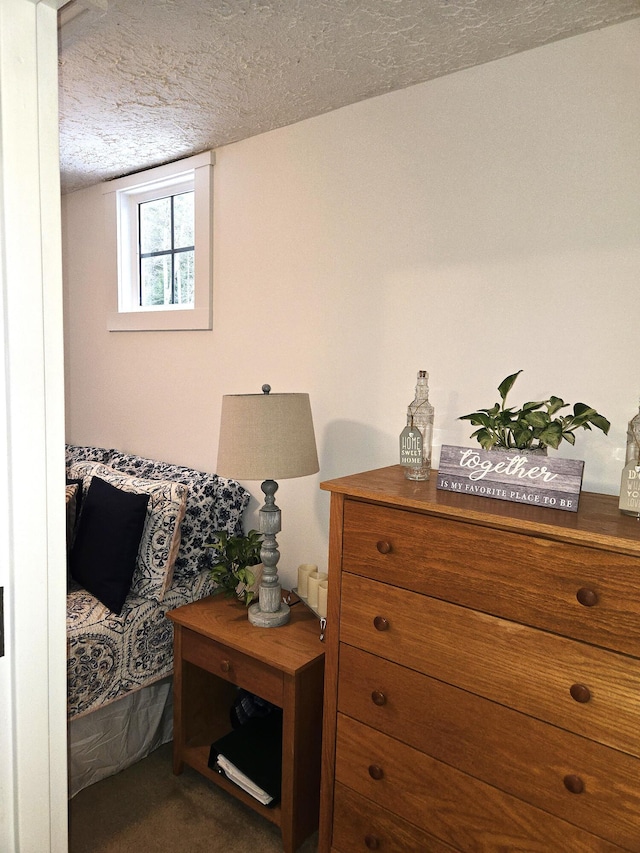 bedroom with carpet flooring and a textured ceiling