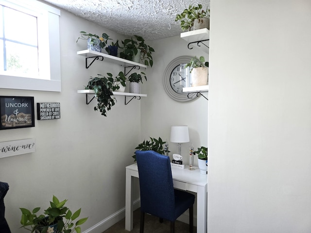 office area with a textured ceiling