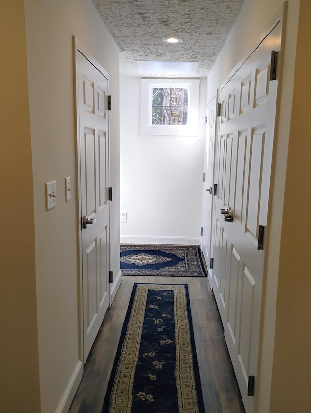 entryway with dark hardwood / wood-style floors and a textured ceiling