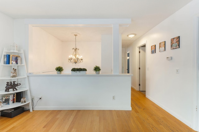 corridor featuring hardwood / wood-style flooring and a chandelier