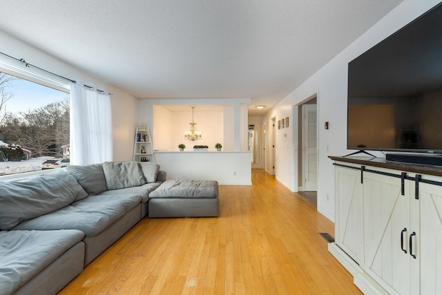 living room with light hardwood / wood-style flooring and a textured ceiling