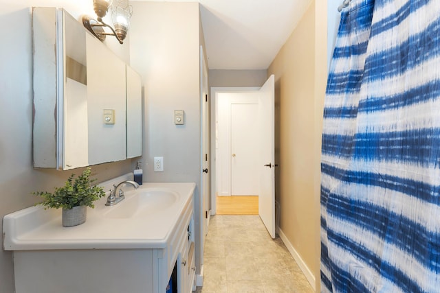 bathroom with vanity and a notable chandelier