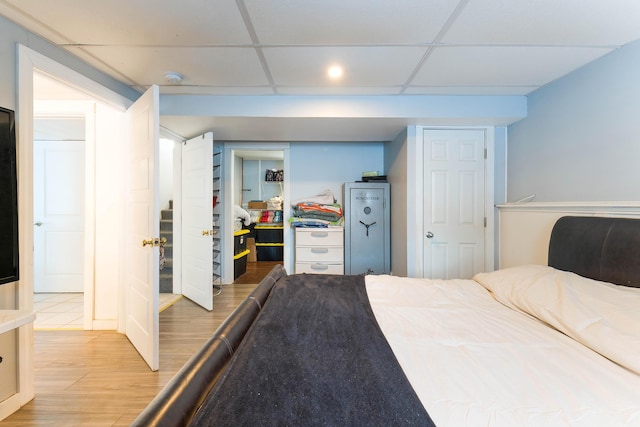 bedroom featuring a paneled ceiling and wood-type flooring