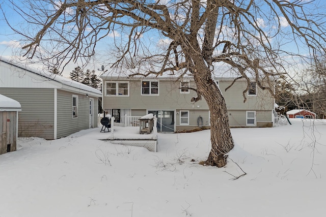 view of snow covered rear of property