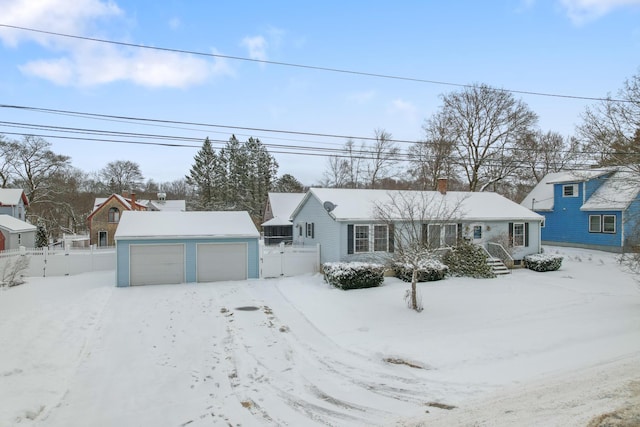 view of front of property featuring a garage and an outdoor structure