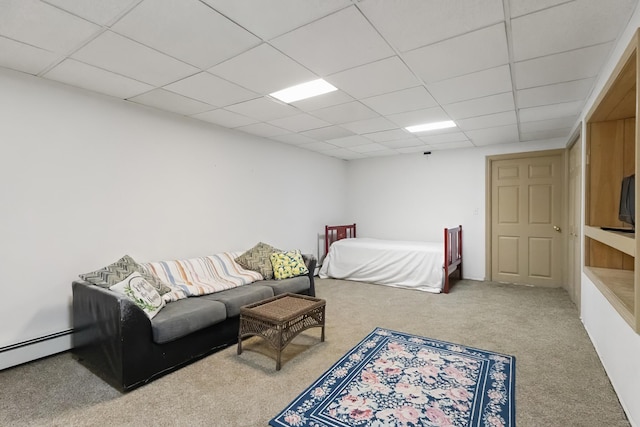 bedroom featuring a baseboard heating unit, carpet floors, and a drop ceiling