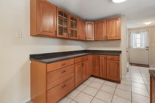 kitchen with light tile patterned floors and a textured ceiling