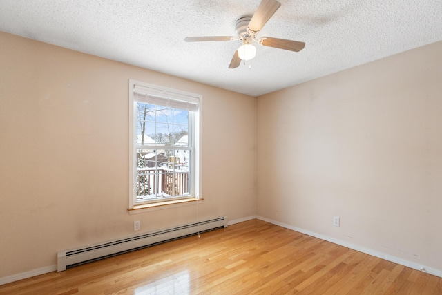 spare room with ceiling fan, light hardwood / wood-style floors, a textured ceiling, and baseboard heating