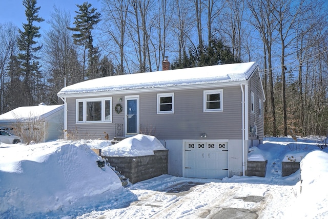 view of front of house with a garage and a chimney