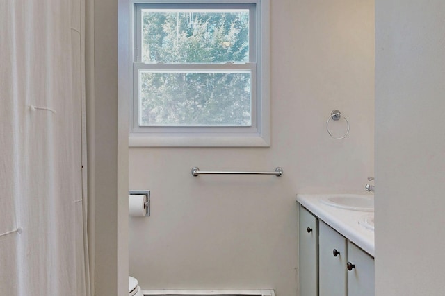 bathroom featuring toilet, a baseboard radiator, and vanity