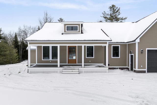 view of front of house featuring a garage and a porch