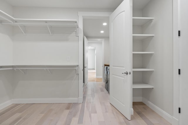 spacious closet featuring light hardwood / wood-style flooring