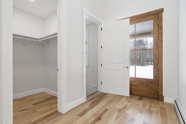 interior space with light hardwood / wood-style floors and baseboard heating