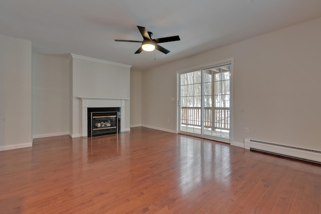 unfurnished living room featuring ceiling fan, hardwood / wood-style floors, and baseboard heating