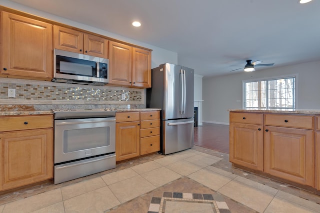 kitchen featuring tasteful backsplash, appliances with stainless steel finishes, light tile patterned floors, and ceiling fan