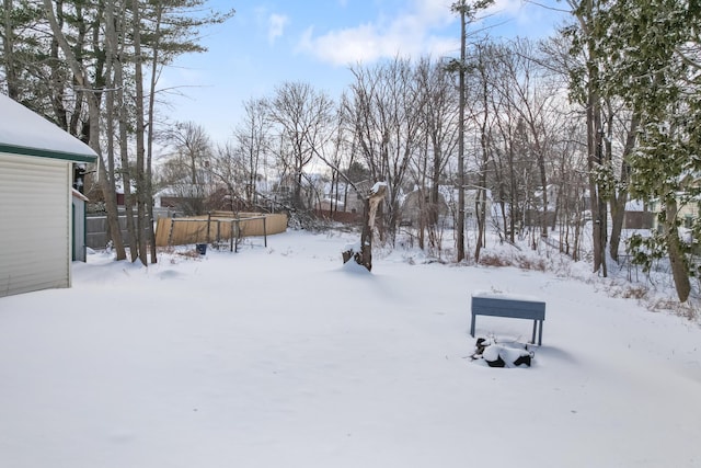 snowy yard featuring a garage