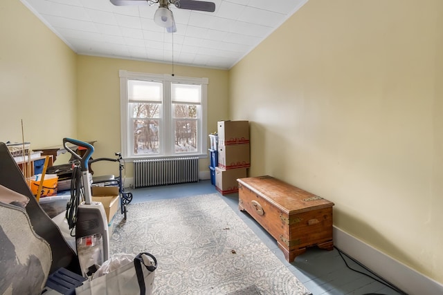 misc room with ceiling fan, baseboards, and radiator