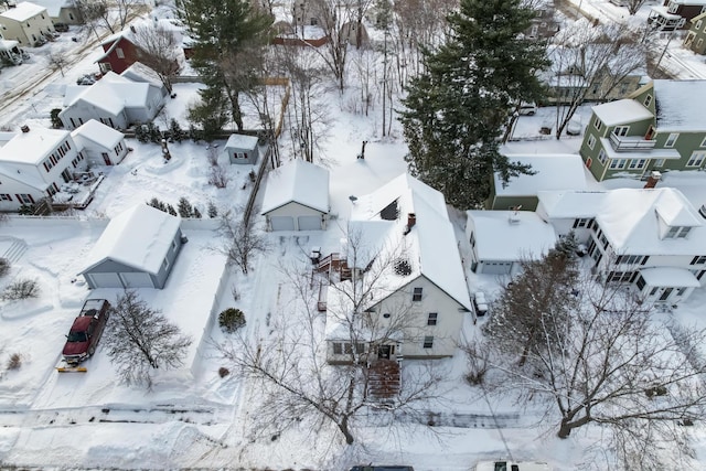 snowy aerial view with a residential view