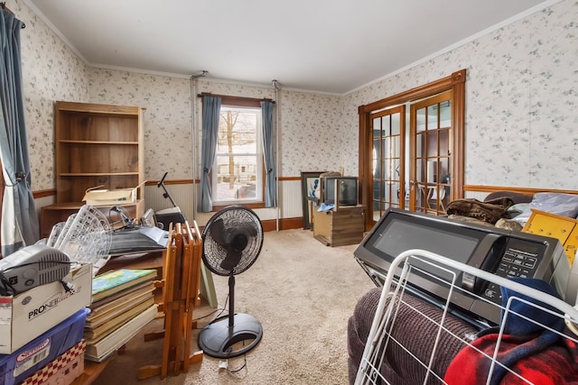 carpeted bedroom featuring ornamental molding, wainscoting, and wallpapered walls