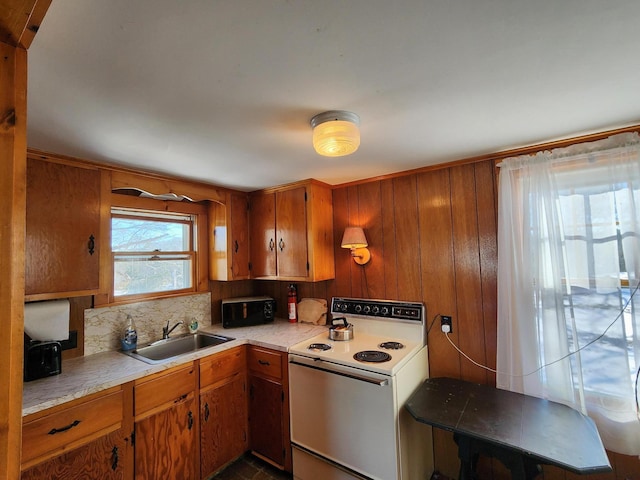 kitchen with white electric stove, sink, backsplash, and wooden walls