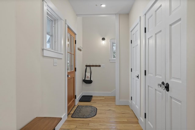 corridor with light hardwood / wood-style floors