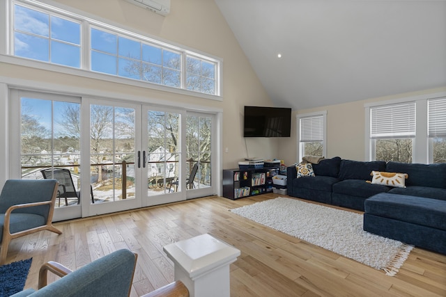 living room featuring high vaulted ceiling, french doors, and light wood-type flooring