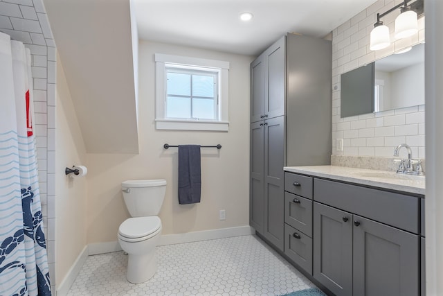 bathroom featuring tile patterned flooring, vanity, and toilet