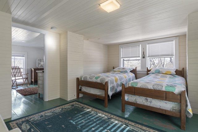 bedroom with dark hardwood / wood-style flooring, wood ceiling, and wooden walls