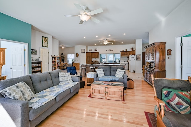 living room featuring ceiling fan and light hardwood / wood-style floors