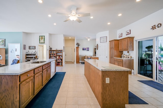 kitchen with ceiling fan, sink, dishwasher, and a large island