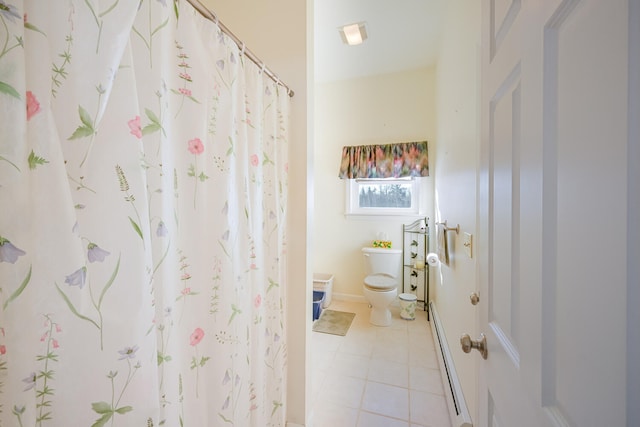 bathroom featuring tile patterned flooring, toilet, and a baseboard radiator