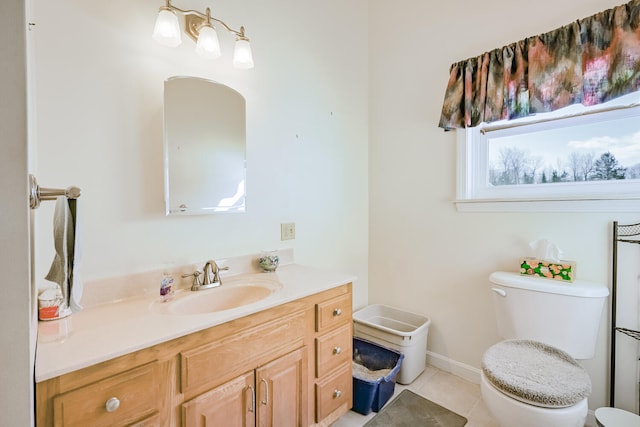 bathroom with tile patterned flooring, vanity, and toilet