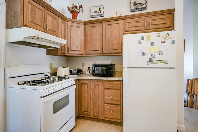 kitchen with white appliances and light tile patterned floors