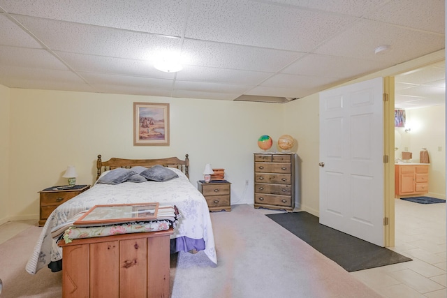 carpeted bedroom with a paneled ceiling