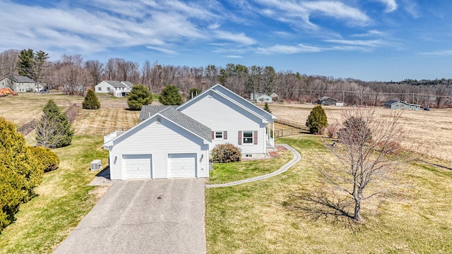 11 Sunrise Dr, Hallowell, ME 04347 - view of front of house with a front yard, fence, a garage, and aphalt driveway