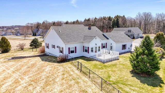 11 Sunrise Dr, Hallowell, ME 04347 - rear view of property with a chimney, a lawn, fence, a deck, and roof with shingles