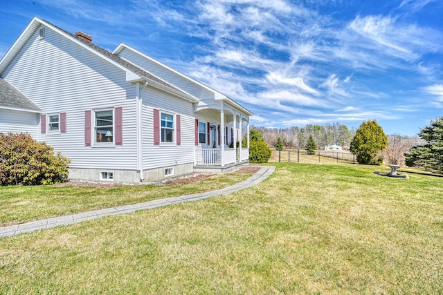 11 Sunrise Dr, Hallowell, ME 04347 - view of home's exterior featuring a porch, a chimney, and a lawn