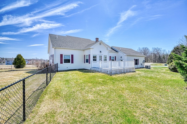 11 Sunrise Dr, Hallowell, ME 04347 - rear view of property with a chimney, a lawn, fence, a wooden deck, and central air condition unit
