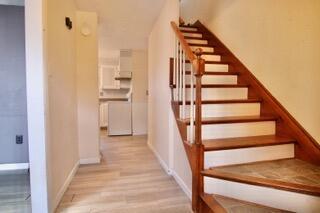 stairs featuring hardwood / wood-style floors