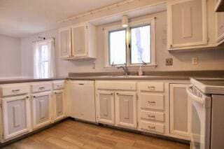 kitchen with white appliances, sink, and light wood-type flooring