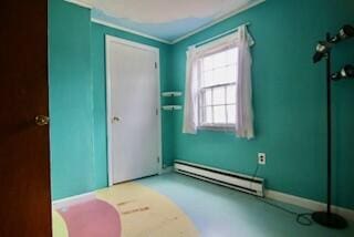 interior space featuring crown molding and baseboard heating