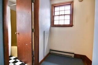 hallway featuring a baseboard heating unit