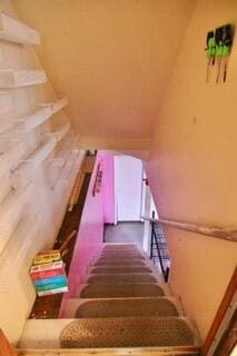 stairway featuring vaulted ceiling