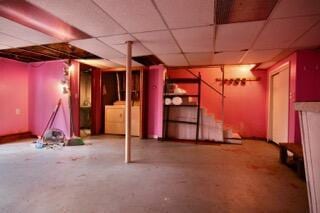 basement with washer / dryer and a paneled ceiling