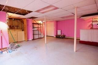 basement with washer and dryer and a drop ceiling